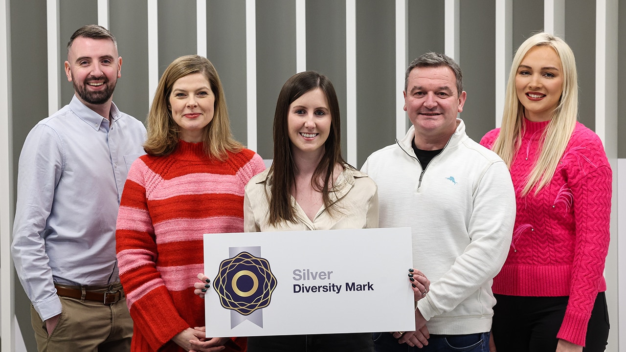 Five Liberty IT employees holding the Silver Diversity Mark award